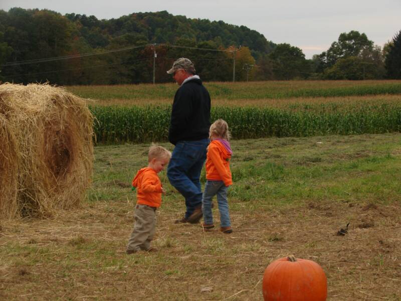 Austin and Abby playing with "Uncle Dewey" in the hay tunnel