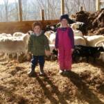 Abby and Austin in barn with easter lambs winter of 2011